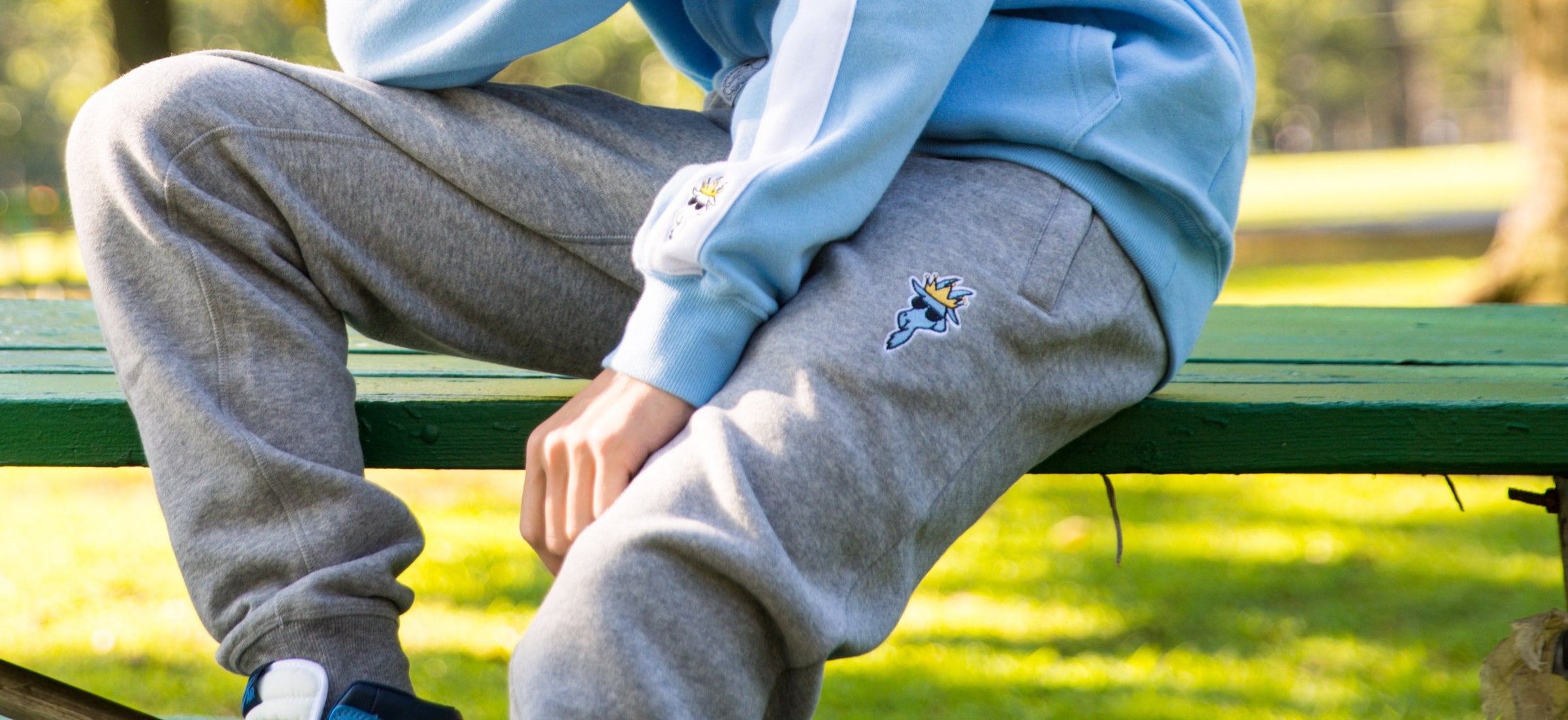 man sitting on a park bench wearing joggers