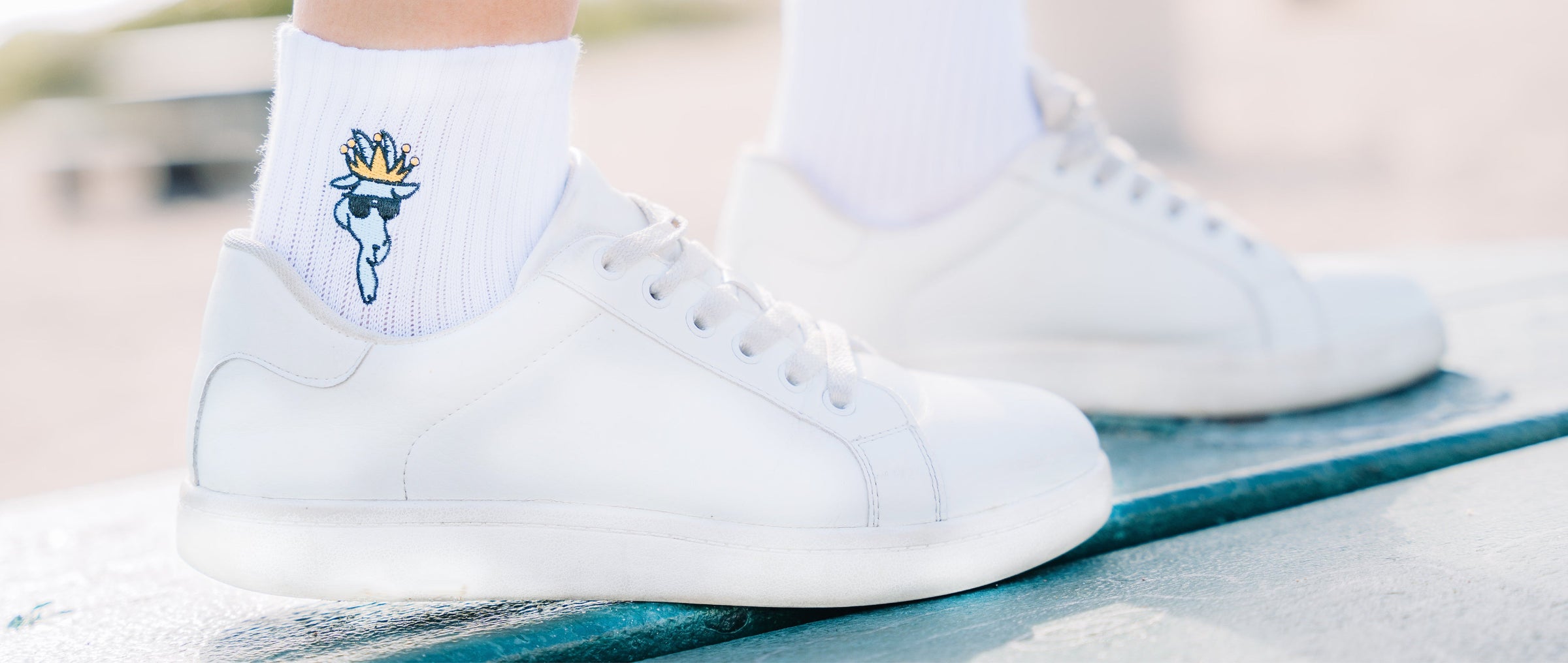 Close up of model wearing ankle GOAT USA ankle socks with white shoes