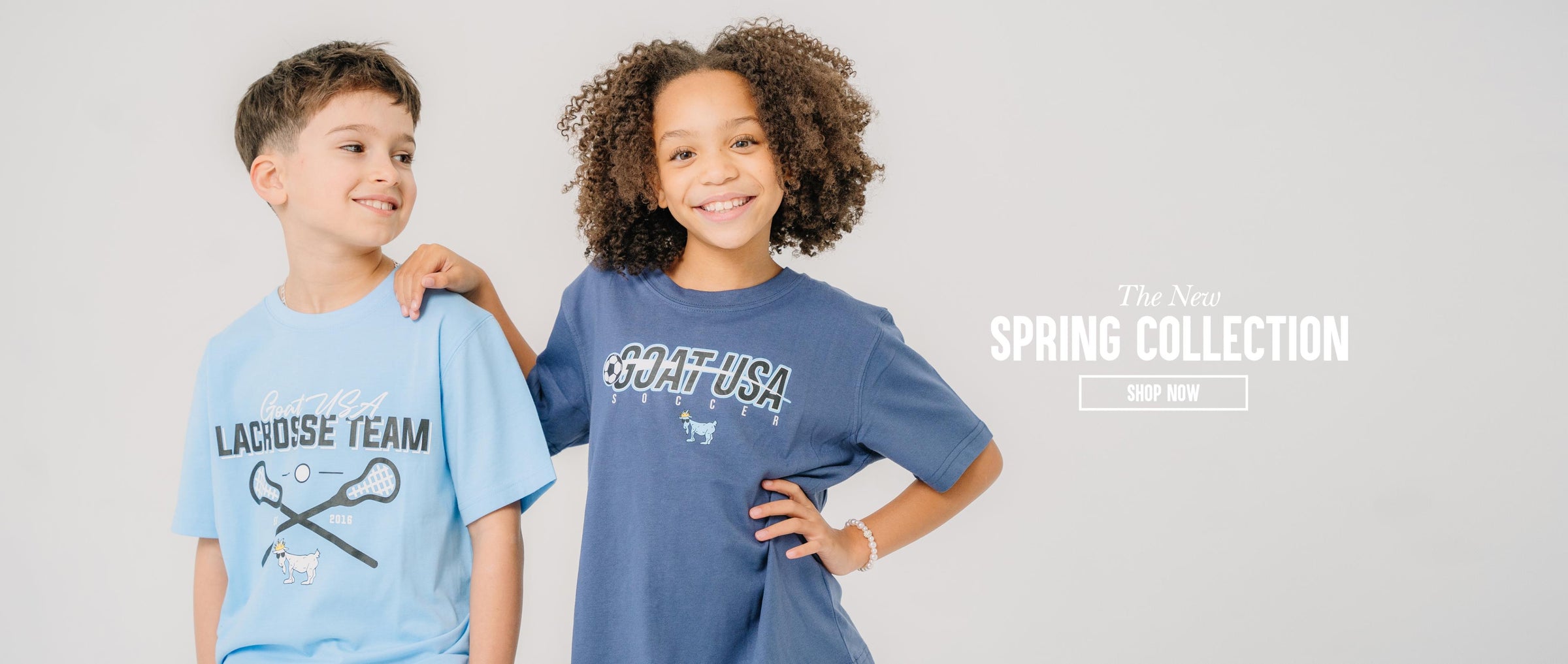 Boy and girl smiling next to text that reads "The New Spring Collection Shop Now"