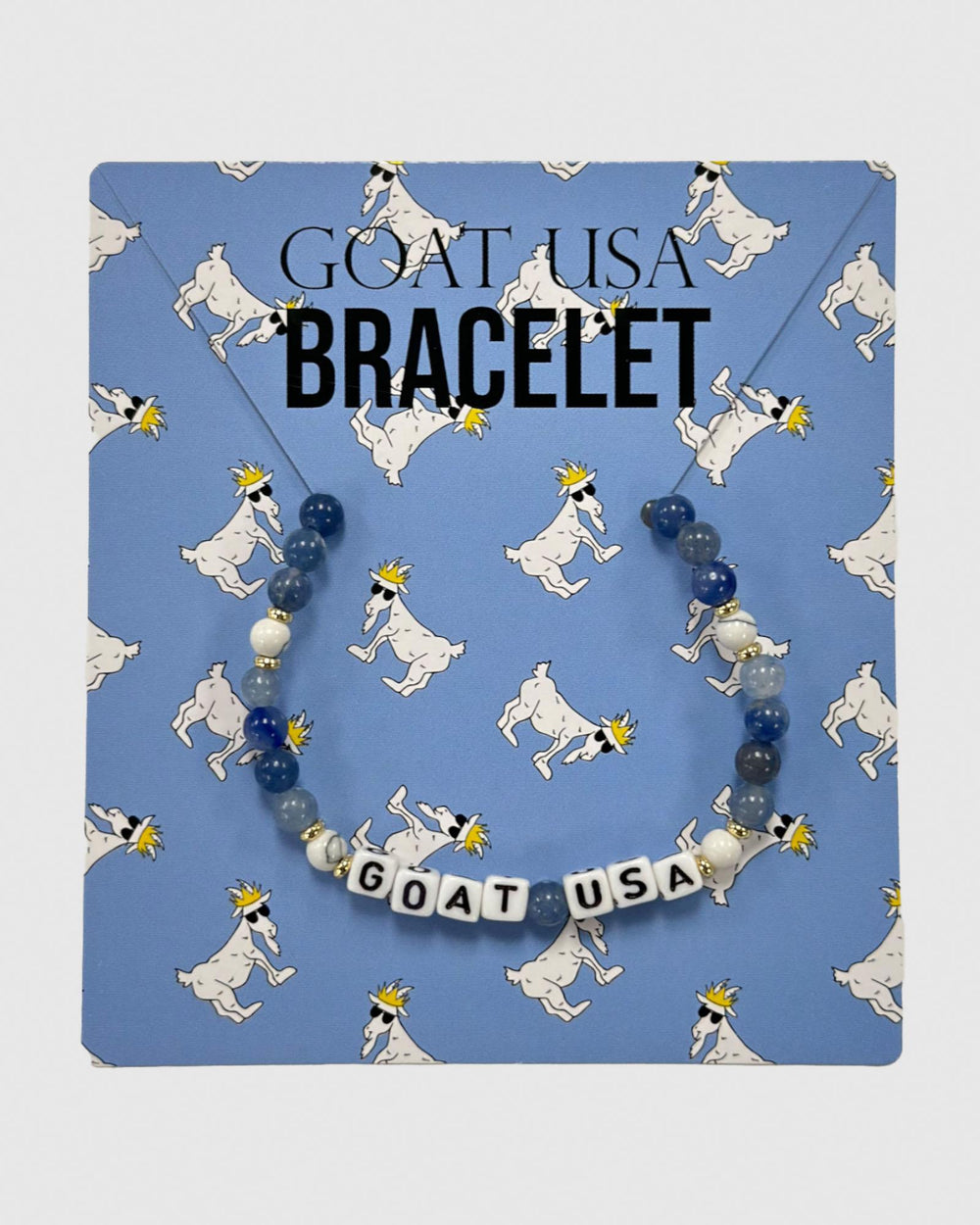 Beaded bracelet displayed on blue card with cartoon goats