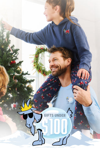 Man with child on shoulders decorating a Christmas tree, promotional graphic for gifts under $100.