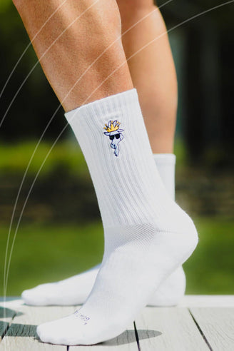 White socks with a cartoon character design worn by a person outdoors.