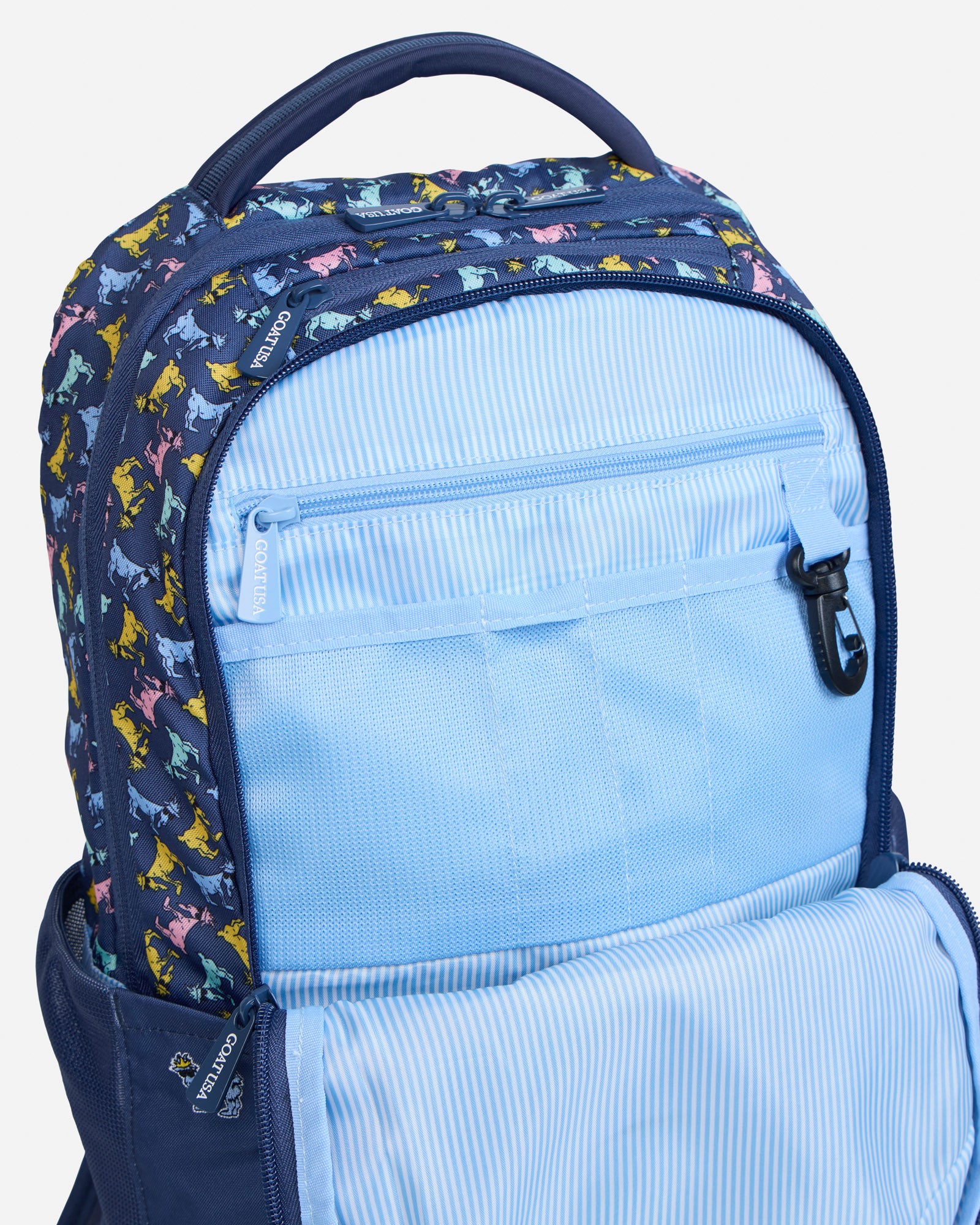 Secondary compartment of navy backpack with all-over-goat pattern
