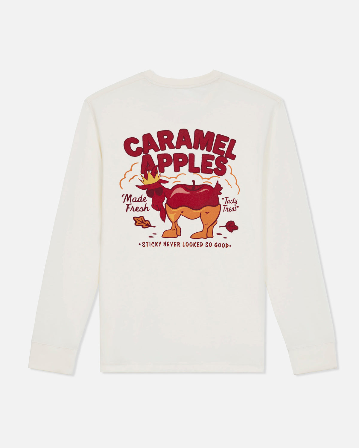 An off-white long-sleeve t-shirt shown from the back, featuring a colorful graphic of a caramel-apple character with the text 'CARAMEL APPLES' and 'STICKY NEVER LOOKED SO GOOD.' on a light gray background.