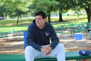 Man sitting on park bench looking into the distance