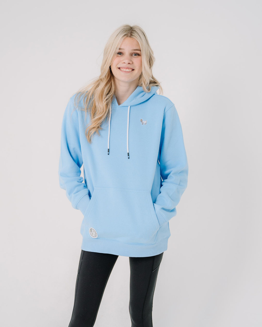 Girl wearing carolina blue sweatshirt with small goat embroidery#color_carolina-blue