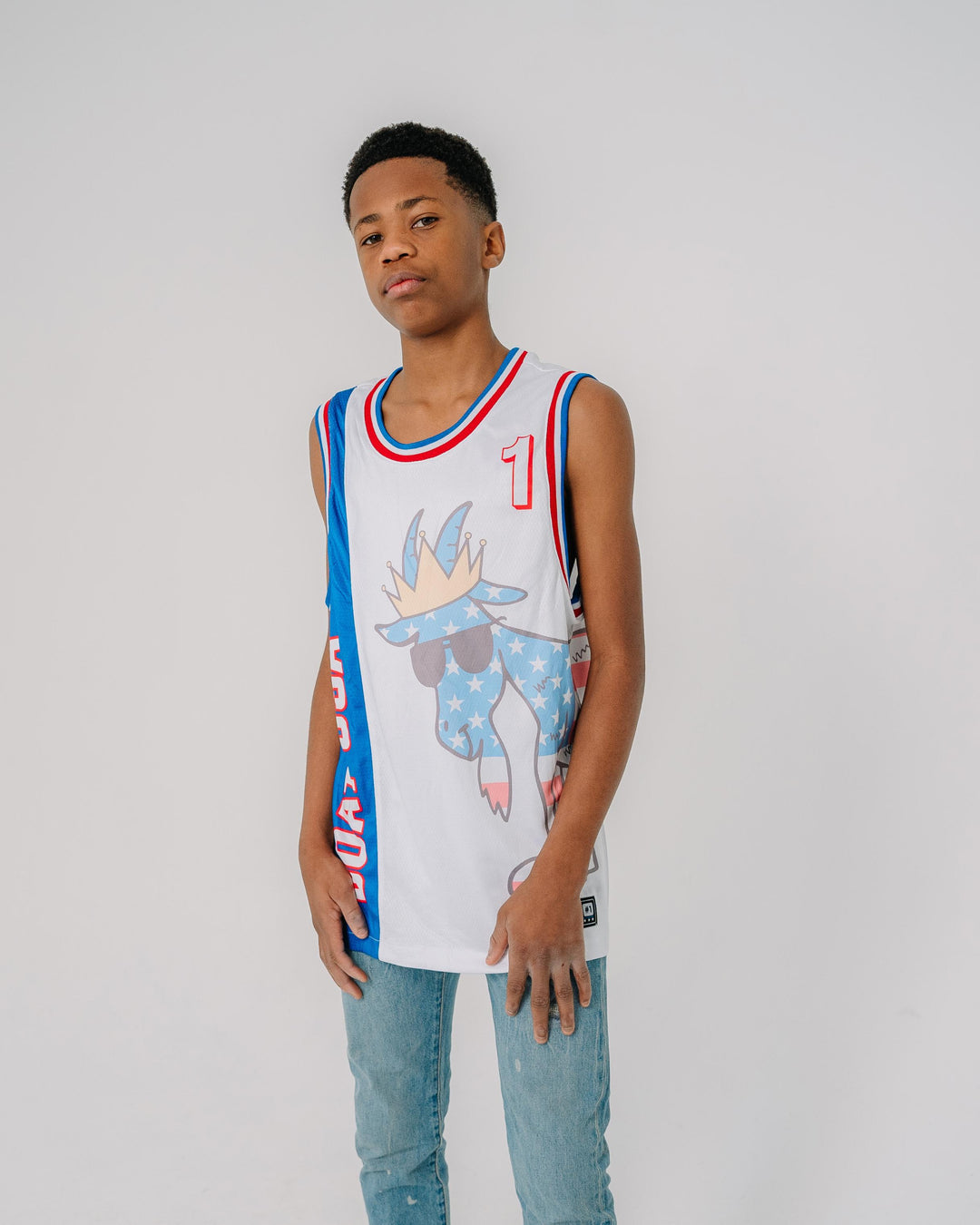 Boy wearing red, white and blue jersey with large American flag goat that wraps around