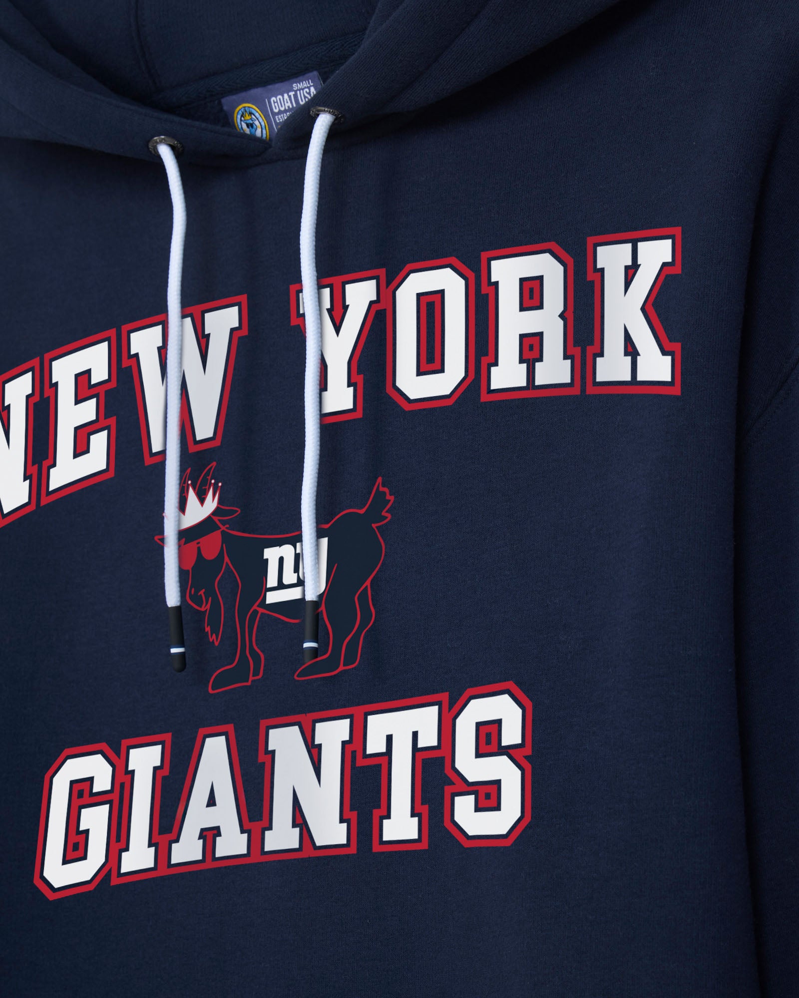 Close-up of a navy blue hoodie featuring 'NEW YORK GIANTS' text and a red-and-white football mascot graphic on the front.