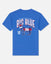 A royal blue short-sleeve t-shirt shown from the back, featuring a large graphic print of the New York Giants 'Big Blue' logo with a stylized goat and 'GOAT USA' text, on a light gray background.