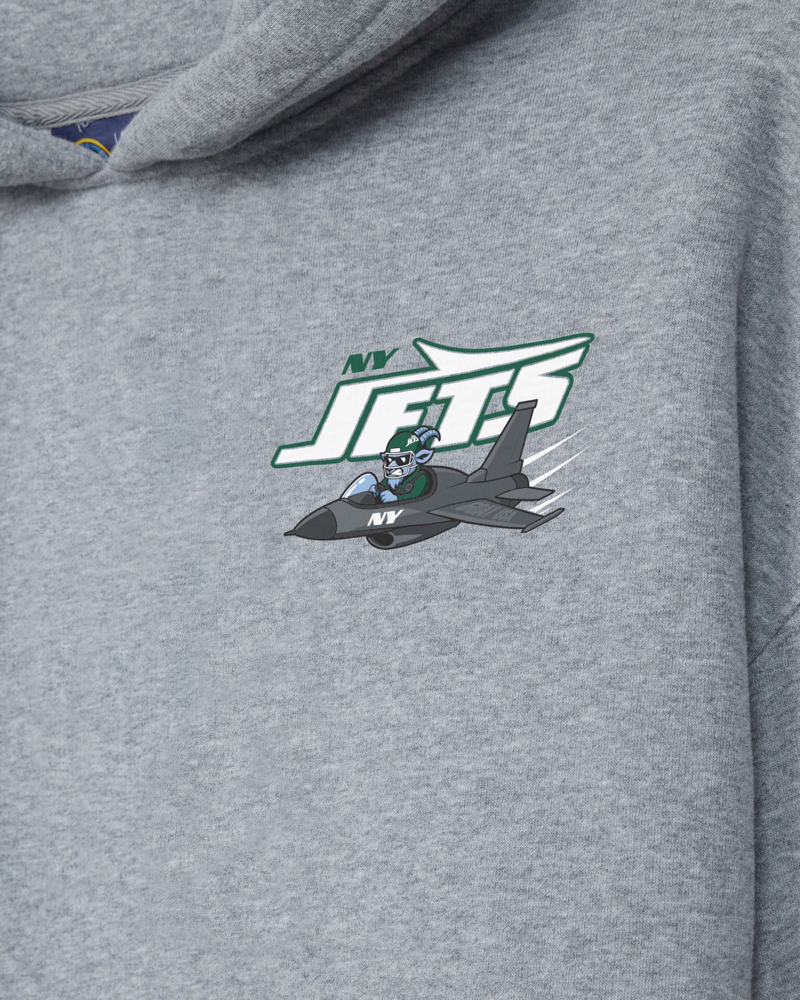 Close-up of a heather gray hoodie featuring a printed New York Jets graphic on the chest, including a jet fighter and the team logo.