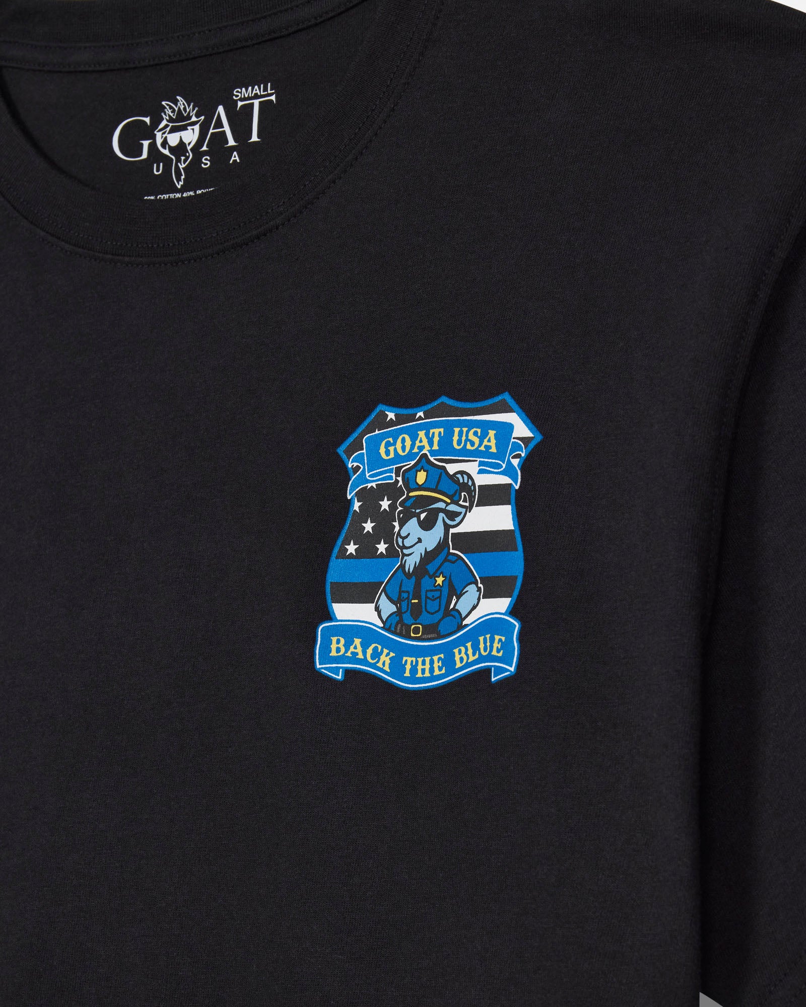 Close-up of a black short-sleeve t-shirt with a blue and white 'GOAT USA Back the Blue' police officer graphic on the left chest.