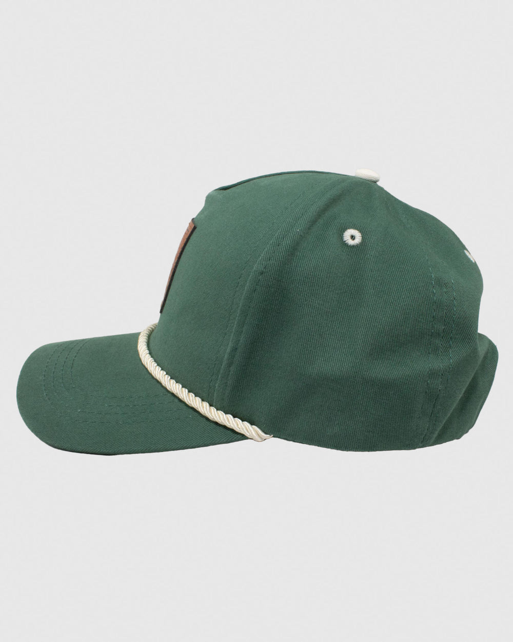 Side of green snapback with cream-colored rope and brown patch