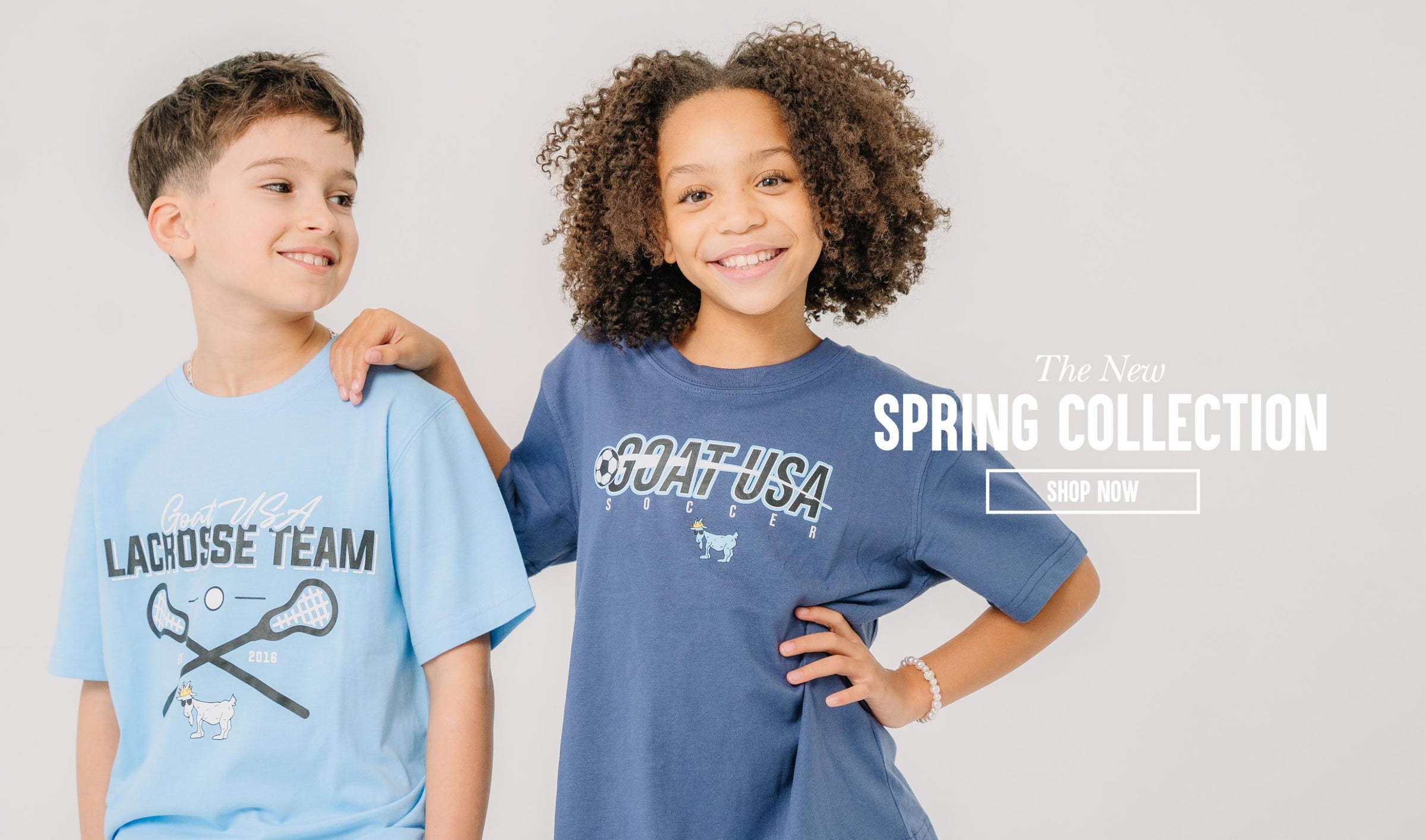Boy and girl smiling next to text that reads "The New Spring Collection Shop Now"