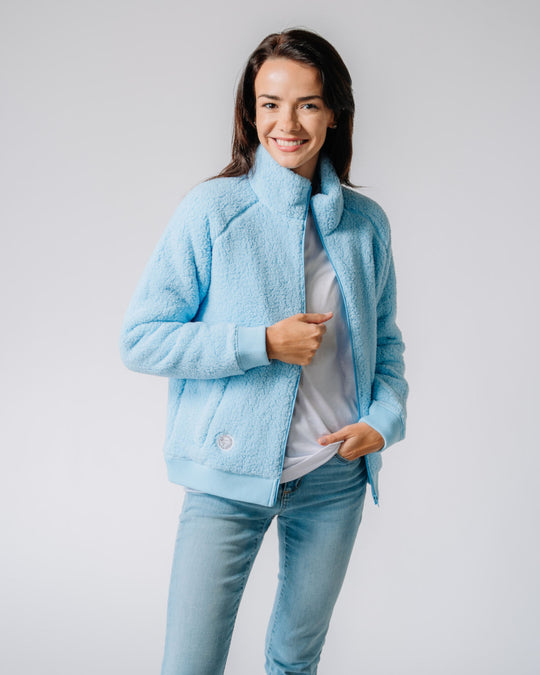 Model wearing carolina blue Women's Sherpa Full Zip Jacket#color_carolina-blue
