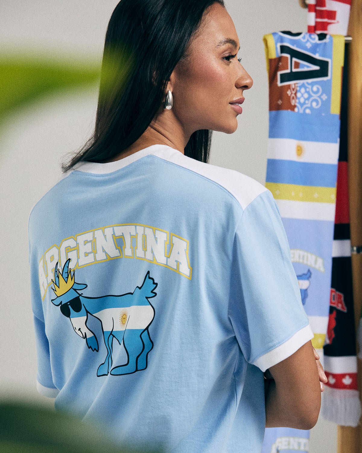 Person wearing a light blue Argentina-themed shirt with a goat graphic.