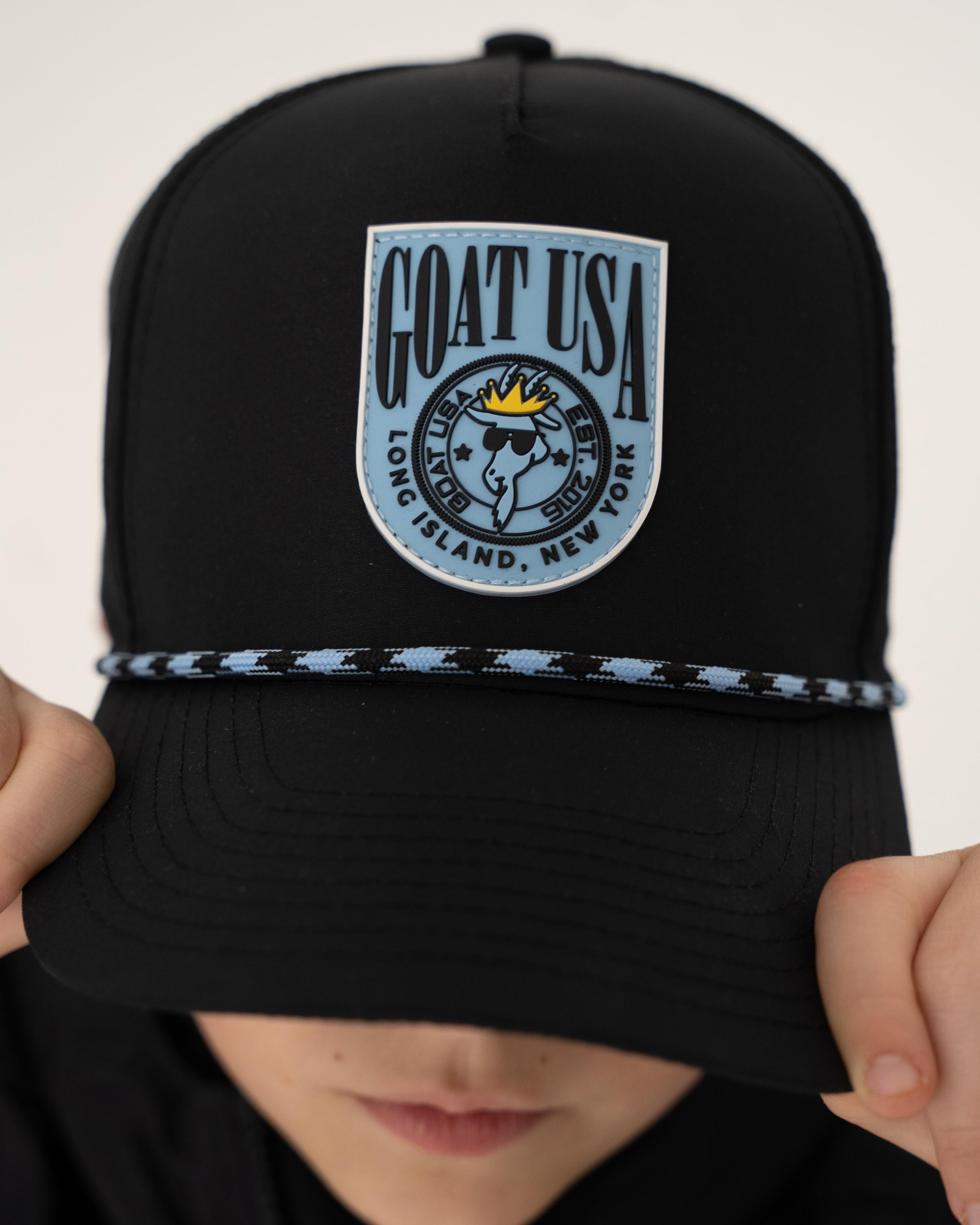 Kid holding brim of black trucker hat#color_black