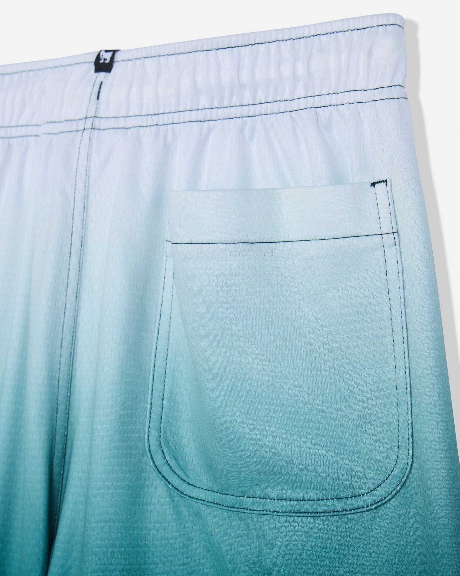 Close-up of back pocket on sage fade mesh shorts#color_sage