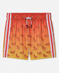 A pair of athletic shorts featuring a warm gradient from orange to yellow, covered in a repeating pattern of cartoon goats. It has white side stripes and a white drawstring.