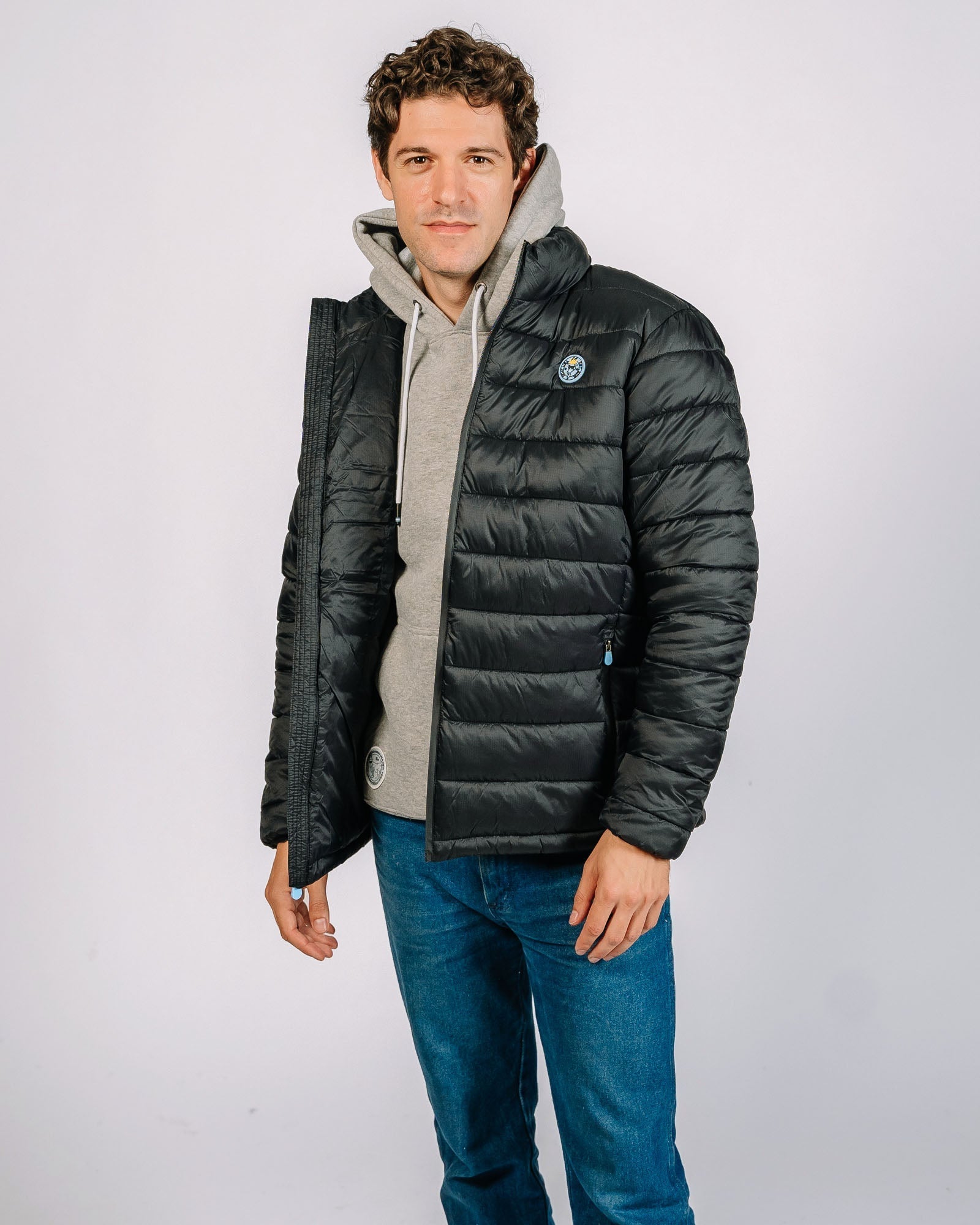 Male model posing in black puffer jacket#color_black