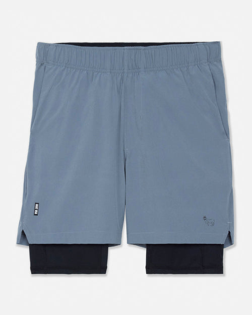 Pair of gray shorts with a black liner on a white background#color_storm-gray