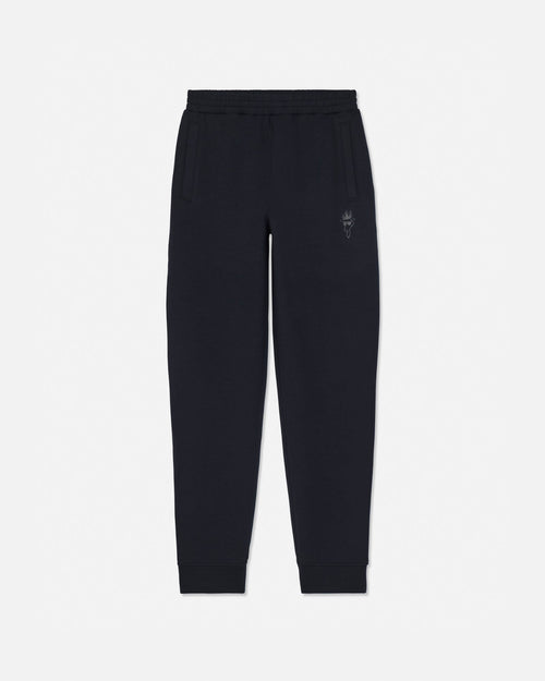 Black sweatpants with an elastic waistband, side pockets, and a small embroidered logo on the left thigh, shown against a plain light gray background.#color_black