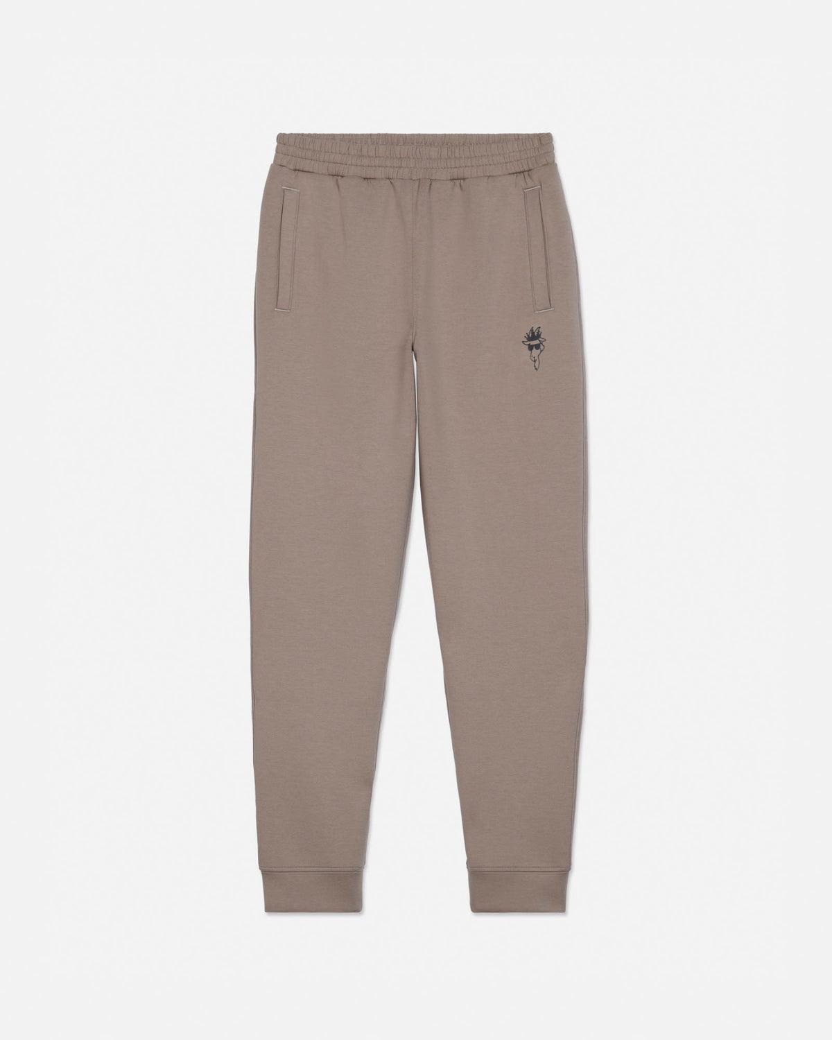 A pair of beige sweatpants with an elastic waistband, side pockets, and a small embroidered rose logo on the left thigh, shown against a plain light gray background.#color_desert-taupe