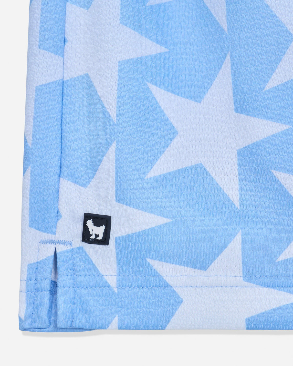Close-up of rubber patch of carolina blue mesh shorts with a star pattern