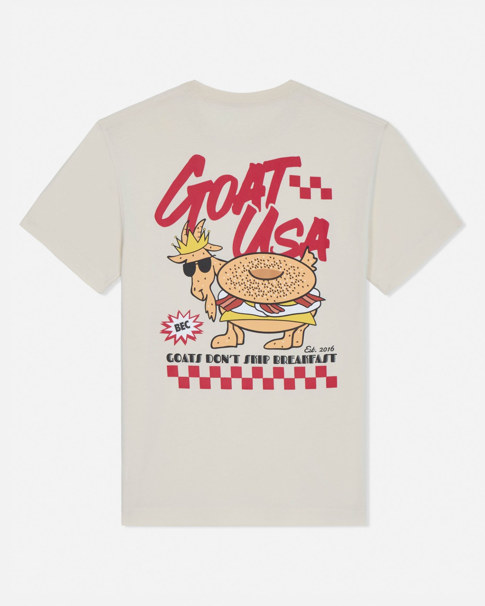 Beige t-shirt with a cartoon goat wearing sunglasses and a crown, labeled 'GOAT USA', on a white background.
