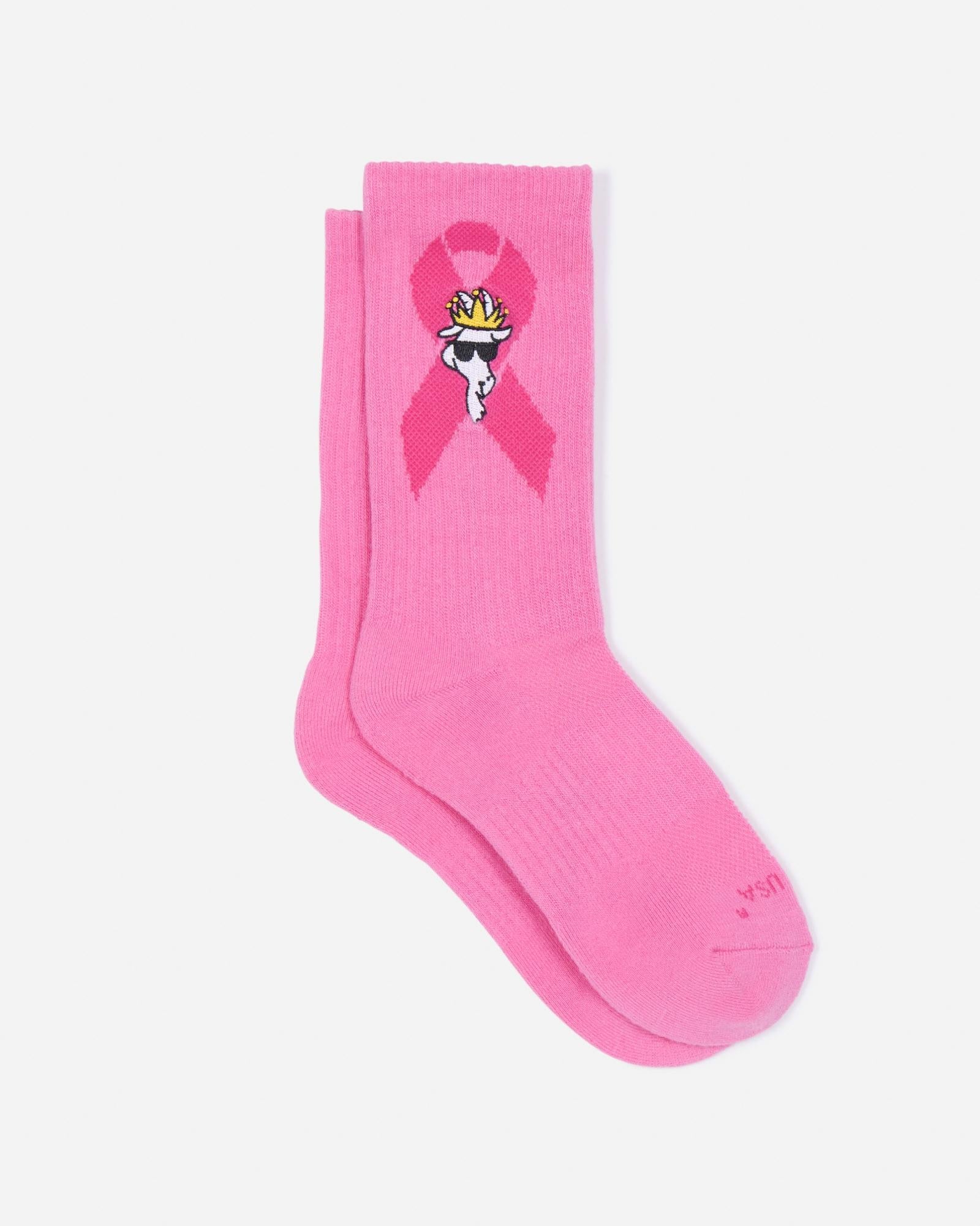Pink socks with the Breast Cancer Awareness logo and a white goat