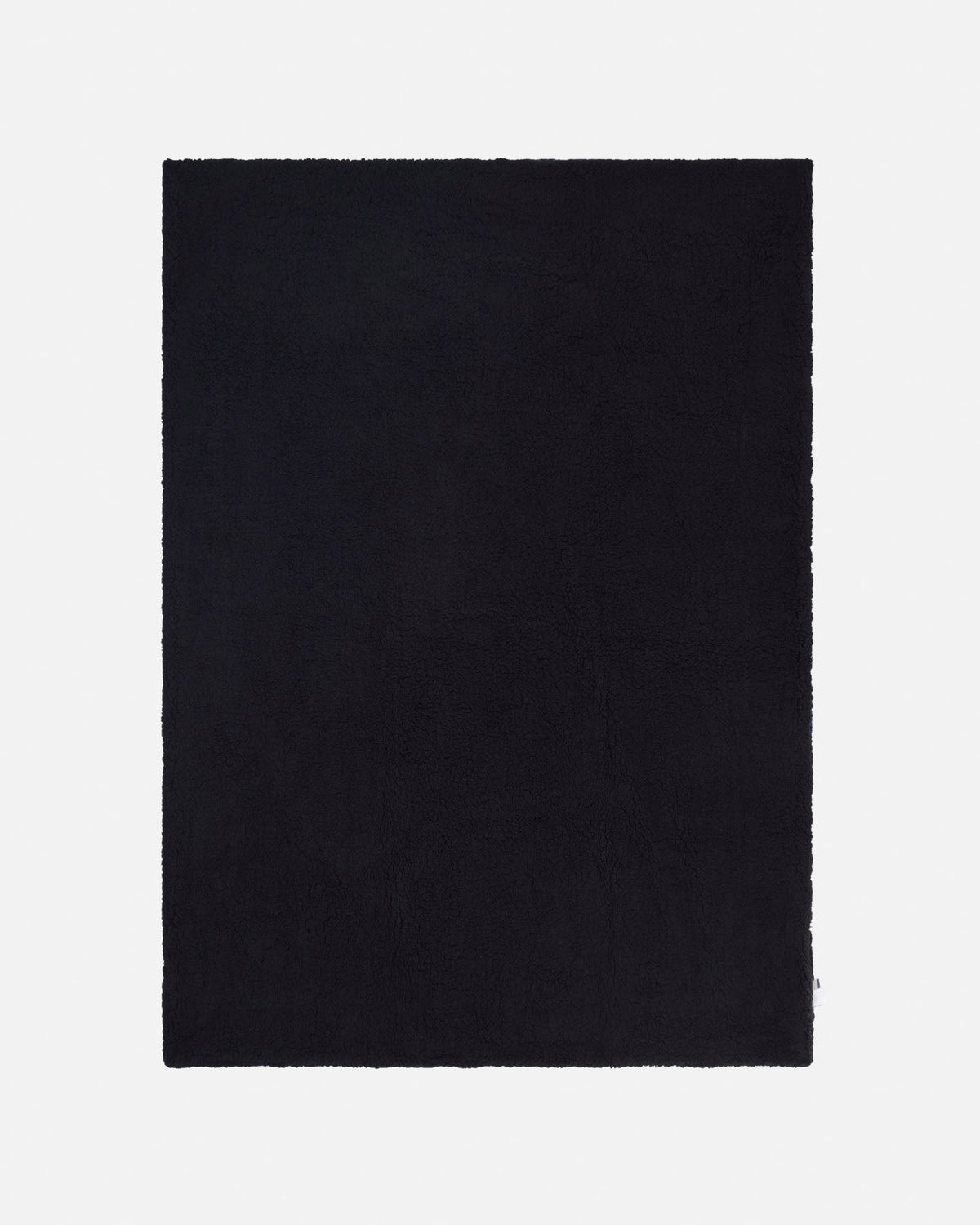 A solid black rectangular blanket with a slightly textured, open-pile surface, shown flat against a light gray background.