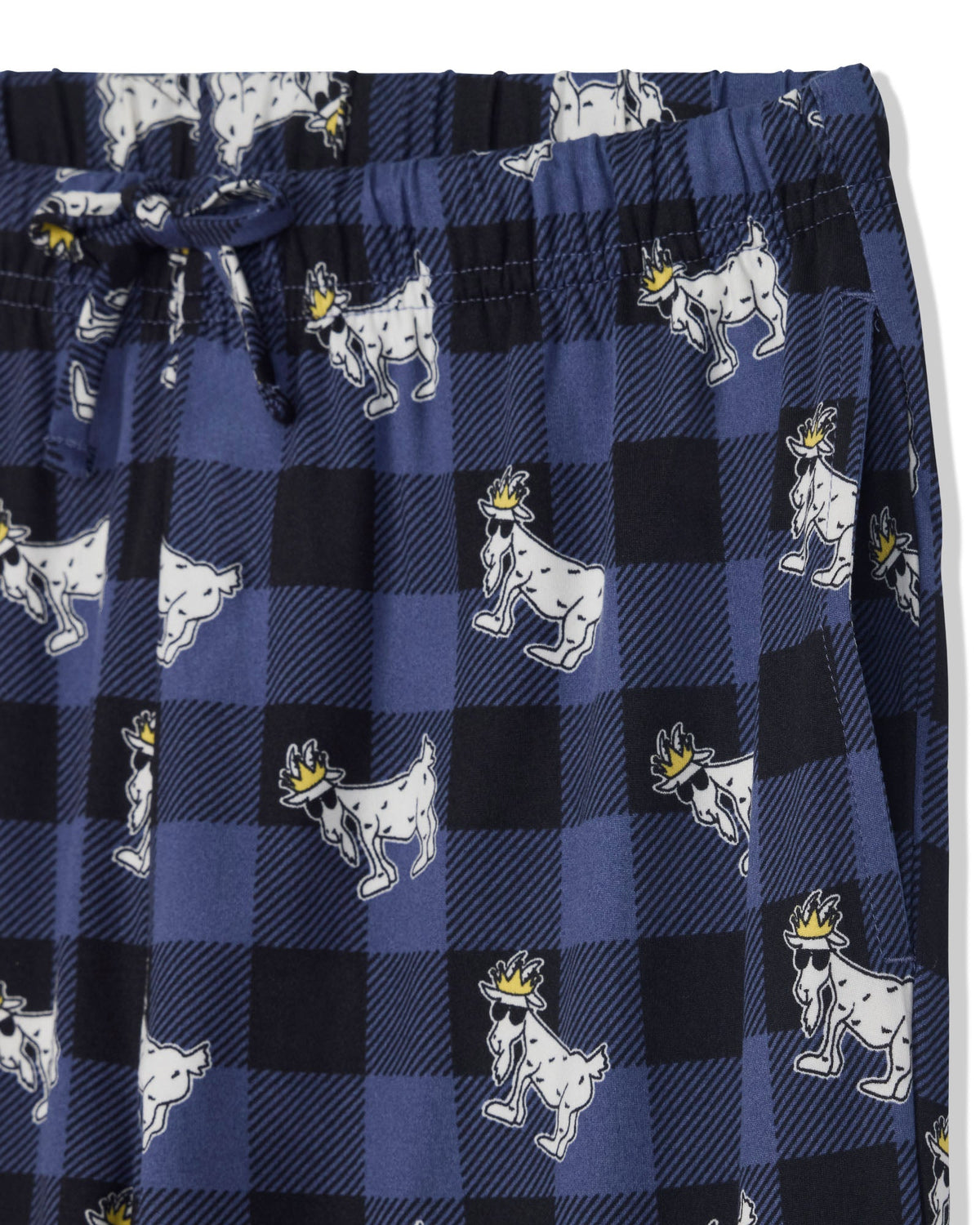 Close-up of a pair of pajama pants featuring a navy and black buffalo plaid pattern with white cartoon goats wearing small yellow crowns, plus a matching drawstring waist.