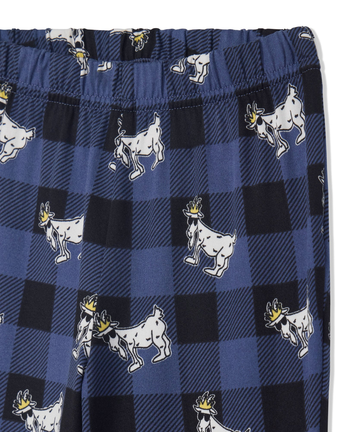 Close-up of a pair of blue and black buffalo plaid pants featuring a repeating pattern of white goats wearing small gold crowns.