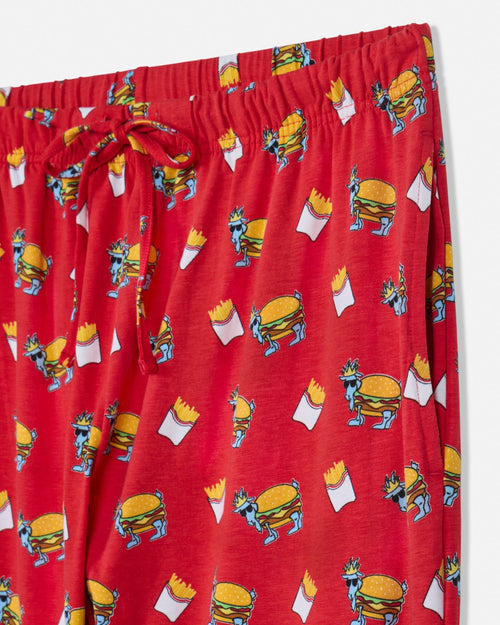 Red pajama pants with cartoon burger and fries pattern on a white background