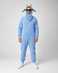 A man modeling a light blue full-body hooded onesie costume with a faux-fur face, blue pointed ears, and a small yellow crown on the hood, photographed against a plain light gray studio background.