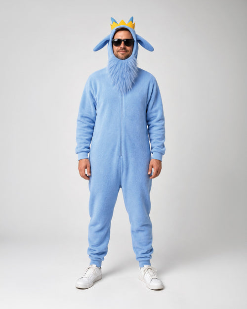 A man modeling a light blue full-body hooded onesie costume with a faux-fur face, blue pointed ears, and a small yellow crown on the hood, photographed against a plain light gray studio background.