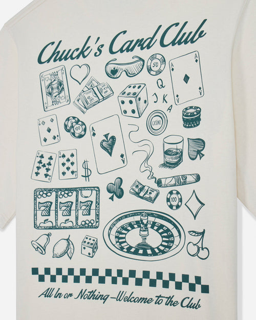 Close-up of bone t-shirt with casino games design and text that reads "Chuck's Card Club All In or Nothing - Welcome to the Club"