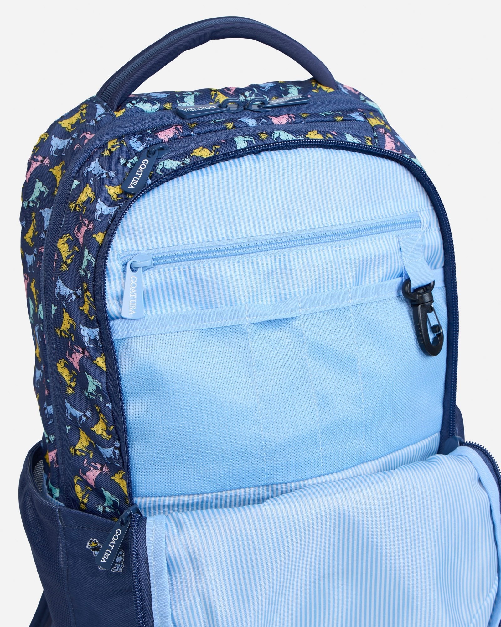 Secondary compartment of navy backpack with all-over-goat pattern