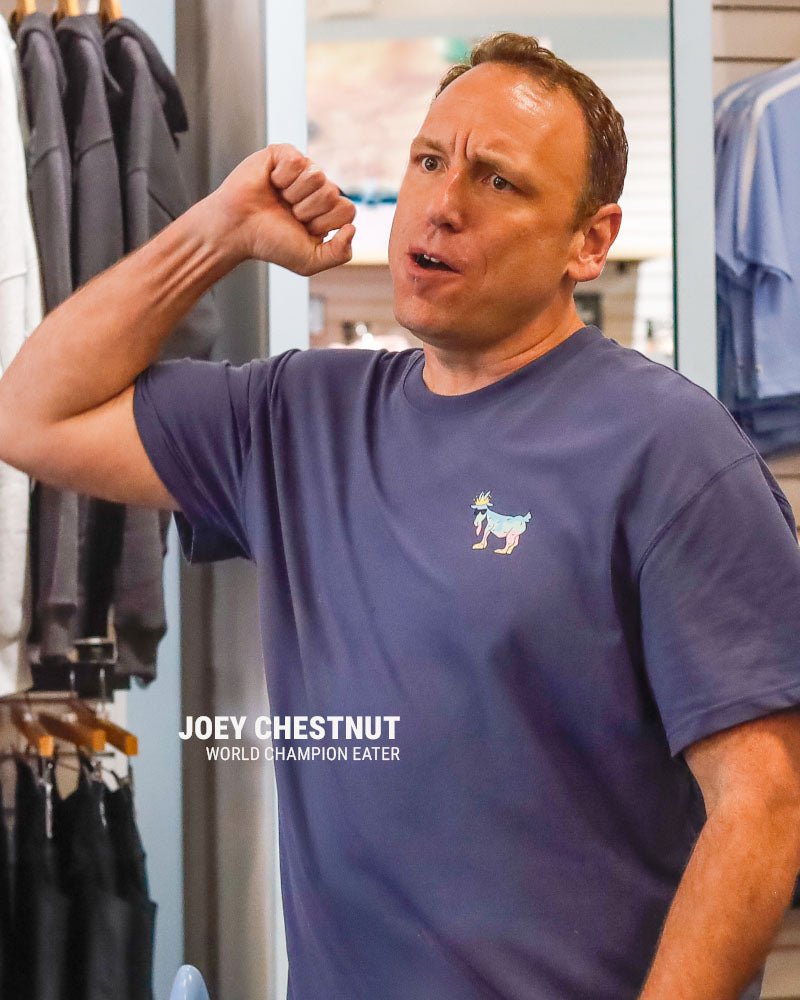 Joey Chestnut pumping his fist and text that reads "Joey Chestnut World Champion Eater"