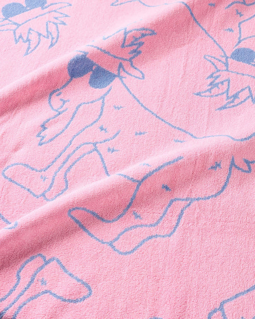 Close-up of pink fabric with blue outlines of goats.