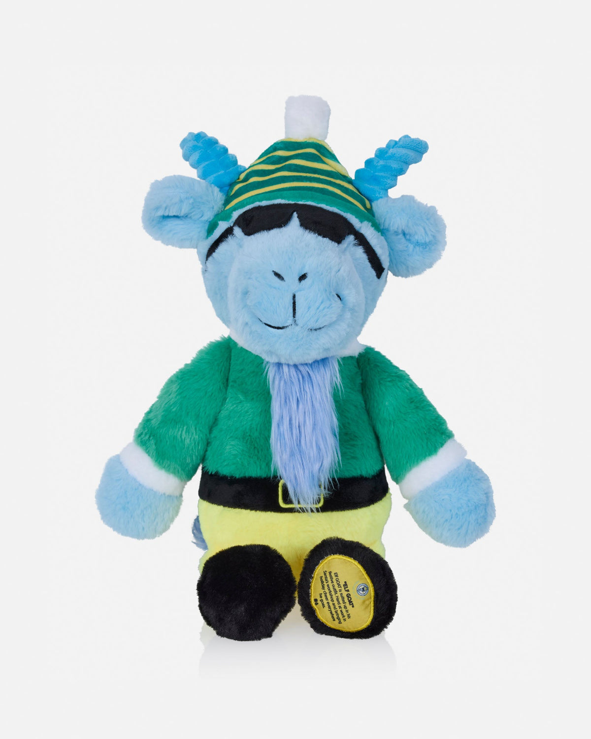 A blue cartoonish plush toy with a green and yellow striped hat, green outfit, yellow pants, and black boots, photographed against a plain light gray background.