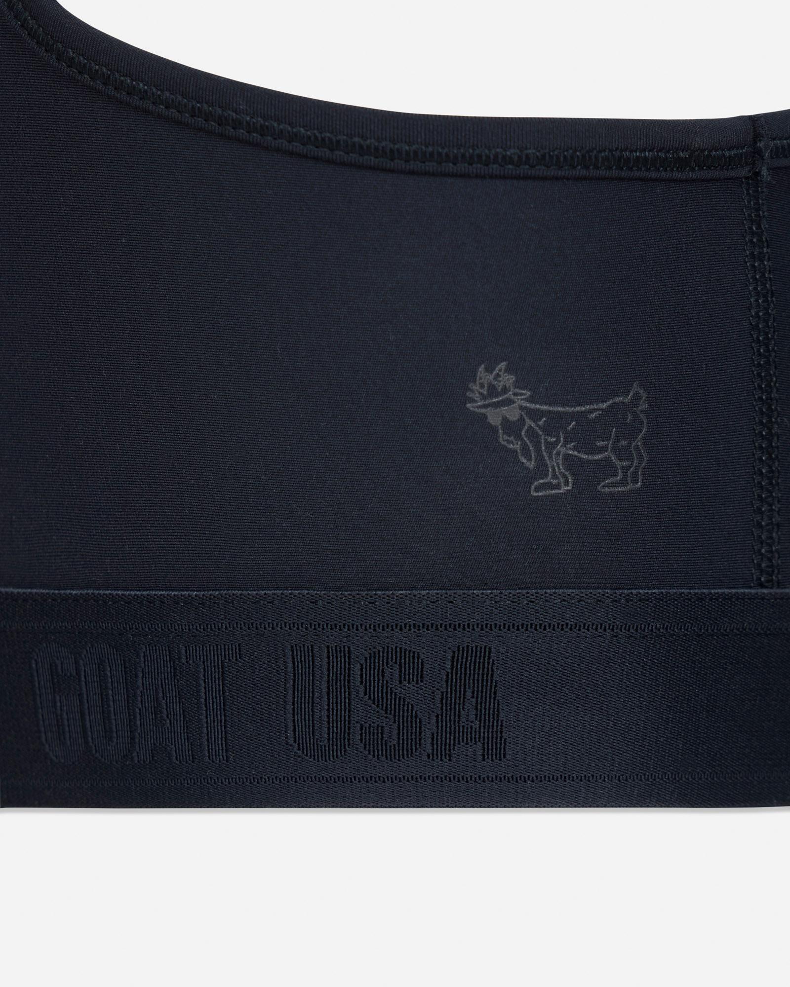 Black sports bra with a small logo and 'GOAT USA' text on a light gray background