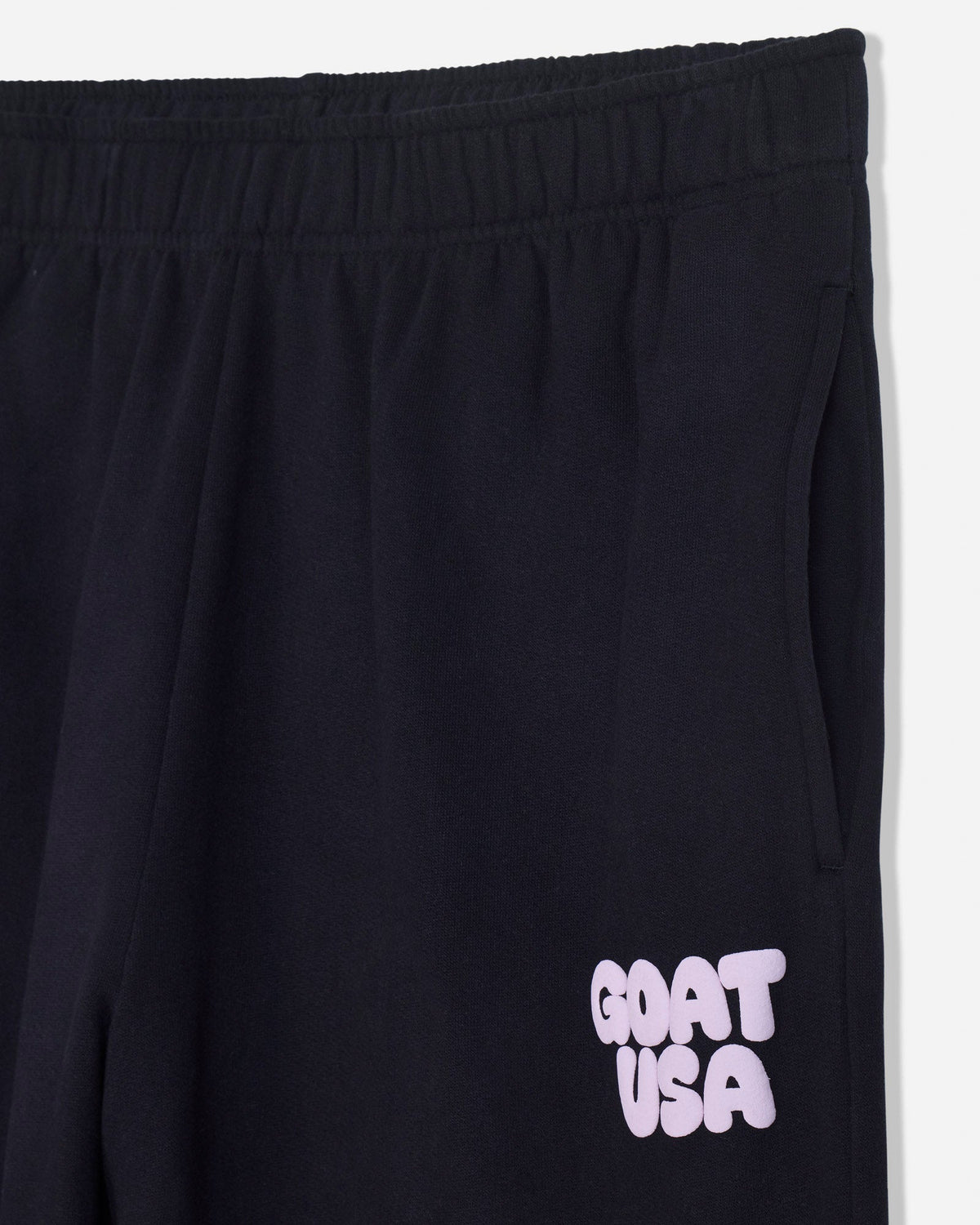 Close-up of pocket on black sweatpants and 'GOAT USA' text
