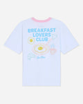 White oversized t-shirt that says 'Breakfast Lovers Club' with various breakfast items