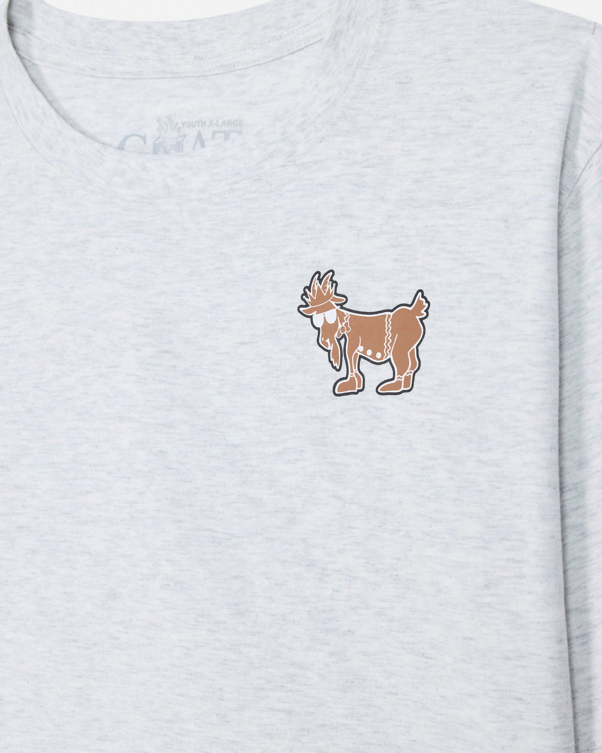 Close-up of a light heather gray t-shirt featuring a small brown and white cartoon goat graphic on the left chest.