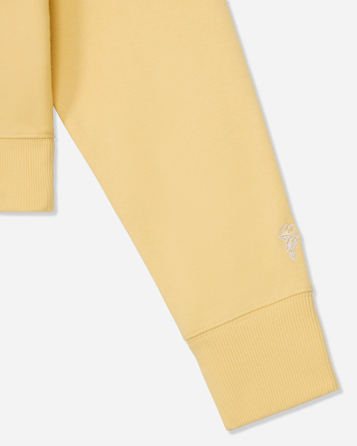 Close-up of sleeve on oversized corn milk crewneck