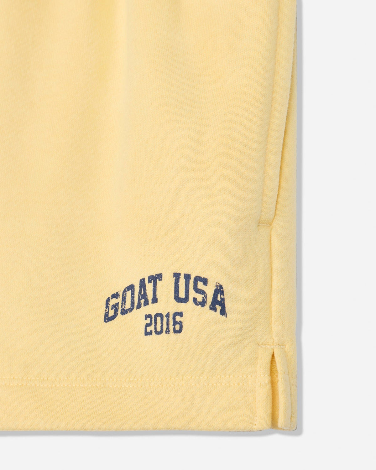 Close-up of corn milk sweat shorts with 'GOAT USA 2016' text