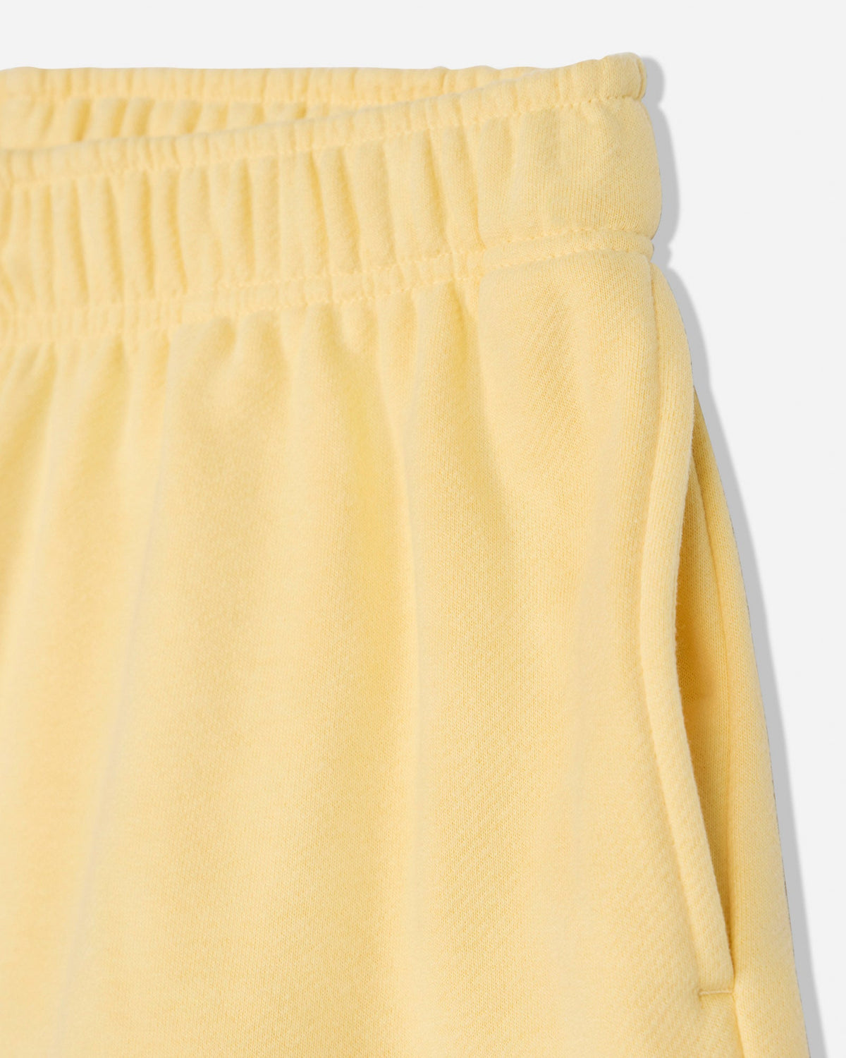 Close-up of pocket of corn milk sweat shorts