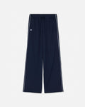 Navy blue wide-leg track pants with white side stripes and a small white embroidered logo on the left thigh, shown against a light gray background.