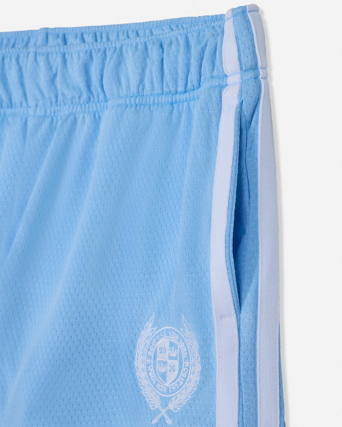 Light blue shorts with a white emblem and trim on a white background
