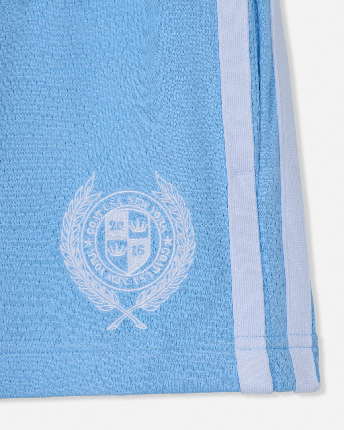 Light blue athletic shorts with a white emblem and stripe on a white background